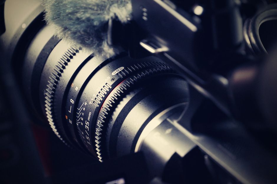 Detailed macro shot of a professional camera lens, showcasing its intricate design and mechanical precision.